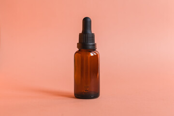 Different serum cosmetic bottles, white and dark brown dropper bottle container and packaging skincare product. studio pastel light background.