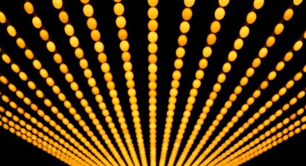 Abstract background of bright golden bokeh lights creating a dynamic sense of perspective and depth.