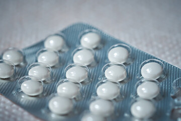 The tablets are round, white, each located in a separate transparent cell.