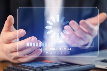 Hands of a person waiting for software update while working at a desk with a laptop