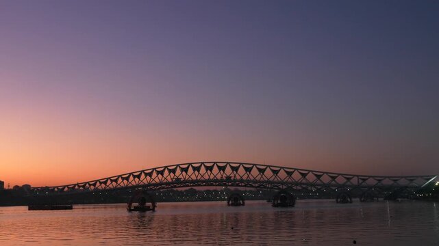 Pedestrian bridge at sunrise over Sabarmati Riverfront, Ahmedabad, Gujarat, India