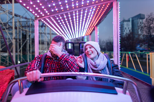 Couple having fun on an amusement park ride