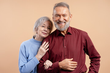 Loving senior couple smiling, embracing, expressing joy and long lasting partnership