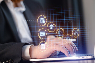 Person using laptop with digital icons representing technology and artificial intelligence at an office setting in the morning
