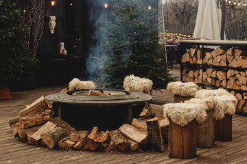 Cozy Outdoor Fire Pit with Wooden Stools and Winter Holiday Atmosphere