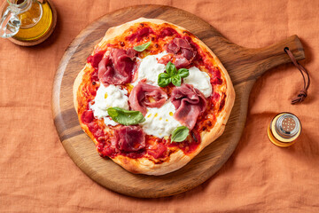 Pizza with Prosciutto Crudo, Stracciatella Cheese and Basil