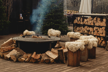 Cozy Outdoor Fire Pit with Wooden Stools and Winter Holiday Atmosphere