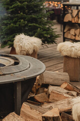 Cozy Outdoor Fire Pit with Wooden Stools and Winter Holiday Atmosphere