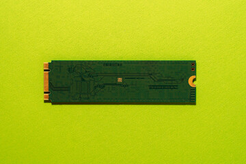 M.2 SSD back side centered on green background, minimal technology concept. High quality photo