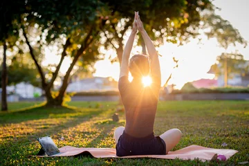 Fotobehang Lotusbloem A young African woman finds zen through a healthy lifestyle, practicing a seated lotus pose for meditation and mental relief.  © Pang