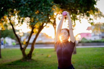 A young African woman finds zen through a healthy lifestyle, practicing a seated lotus pose for...
