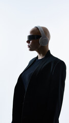 Young woman with shaved head wearing futuristic visor and headphones in profile. Concept of wearable technology, future audio devices, tech branding and product visualization.
