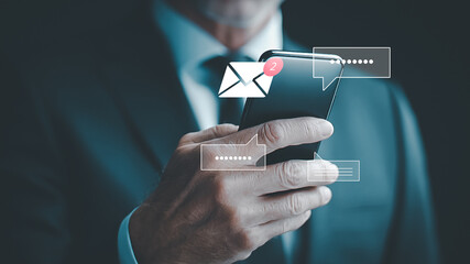 Businessman holding smartphone with message and notification icons, showing digital communication, online messaging, business chat, mobile technology and customer interaction.