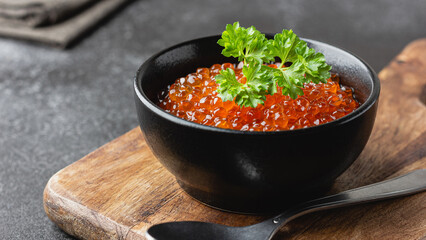 Red salmon caviar with parsley in a bowl
