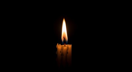 Burning candle with bright flame shining in darkness creates atmosphere of mystery and hope