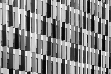 Abstract modern architecture facade with repetitive pattern and geometry shaping urban building design and contemporary exterior