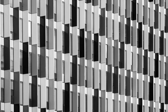 Abstract modern architecture facade with repetitive pattern and geometry shaping urban building design and contemporary exterior