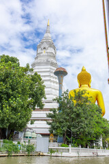 Boat trip in Bangkok, Thailand, with a view of Wat Paknam Bhasicharoen temple from the river