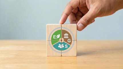 Hand holding a wooden block with a circular diagram showing green brown and white sections on a light brown surface