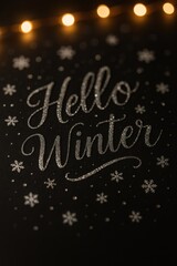 A decorative greeting card with text Hello Winter in elegant script. Small snowflakes and a soft glow from fairy lights
