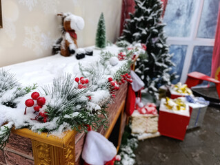 Christmas fireplace decor with garland, gifts and snowy winter interior
