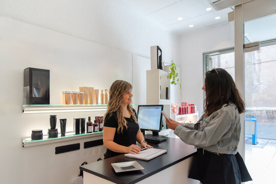 Customer checking out at hair salon reception desk