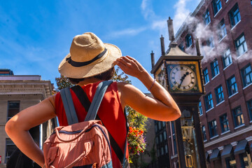 Tourist admiring gastown steam clock in vancouver, british columbia