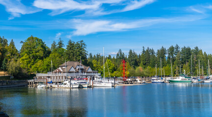 Stanley park seawall showcasing siwash rock, brockton point lighthouse and boats in vancouver, british columbia