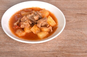 fried mixed vegetable with chop pork bone in sweet and sour gravy sauce on plate 