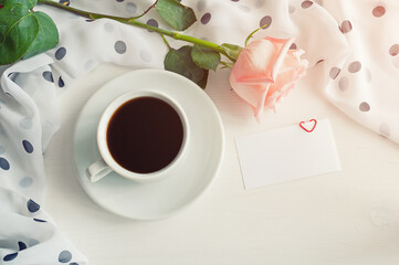 St Valentines day background in vintage tones - cup of coffee, peach rose, blank love card, St Valentines day concept