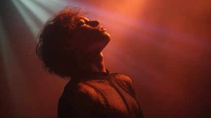 Dramatic silhouette under red stage lighting
