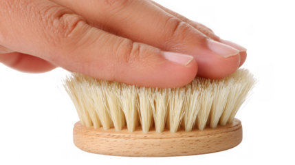 Woman gently touching a small round natural cleaning brush with wooden handle, isolated on transparent background, perfect for hygiene and cleaning concepts