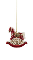 Festive red and white rocking horse Christmas ornament with ornate gold scrollwork and a gold saddle, isolated.