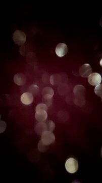 Abstract background of red bokeh on. Black.