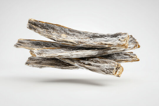 Salted dried cod fish sticks on white background