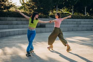 
Women skaters show graceful moves on quad skates in sunset park

