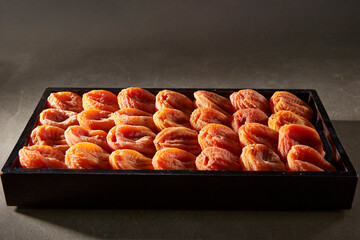 Dried persimmons on a wooden tray
