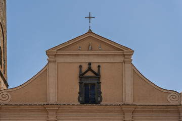  Italy - Bagnoregio - Civita di Bagnoregio - Church of San Donato pediment with cross, statues, and dark-framed window, Renaissance details close-up