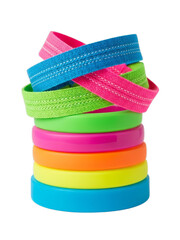 Stack of colorful textured ribbon rolls arranged in a playful vertical composition, vibrant craft and decoration materials isolated on white background