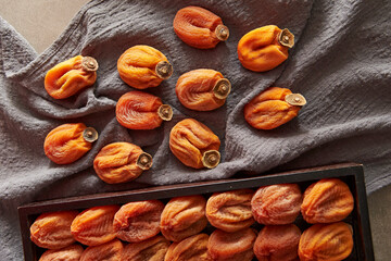 Dried persimmons on a wooden tray
