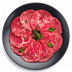 Slices of thinly sliced, raw meat arranged on a dark plate.  Spices and fresh herbs are scattered among the slices