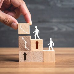 A hand places a wooden block, part of a staircase, on which a person figure is walking.  Other blocks with walking figures and arrows