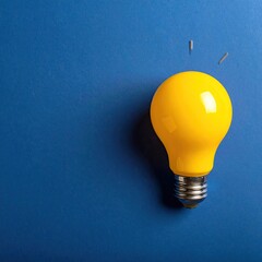 Bright yellow lightbulb on a deep blue background