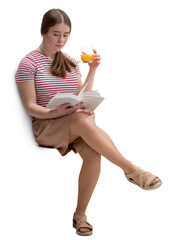 Young woman relaxing while reading a book and enjoying a refreshing glass of orange juice. She is casually dressed
