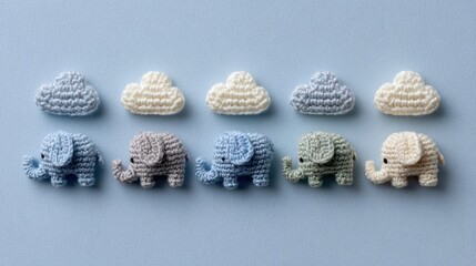 Row of adorable handmade crochet elephant toys in pastel colors arranged with soft knitted clouds on a light blue background, perfect for baby, nursery, and children concepts.