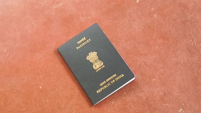 Passport of india official government citizenship identification document dropped or fall down on floor from careless traveler or pickpockets dump after stealing. Indian id proof lost or loss concept.