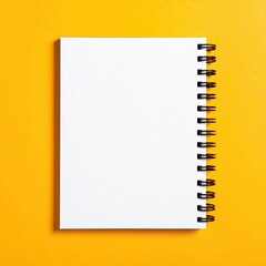 Blank spiral-bound notebook on a vibrant yellow background