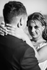 The meeting and walk of the bride and groom on the sandy seashore