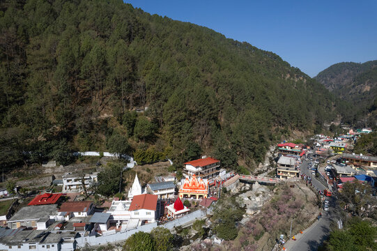 NAINITAL, UTTARAKHAND, INDIA - MARCH 15, 2024 : Aerial drone view of the famous Kainchi Dham Temple (Neem Karoli Baba Ashram) situated in the Kumaon hills.