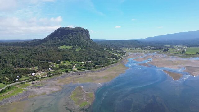 Hualaihue, Chile: Aerial drone footage of Hualaihue, rural area in Lake district of Chile with mountain in the background near Hornopiren. Taken with forward motion